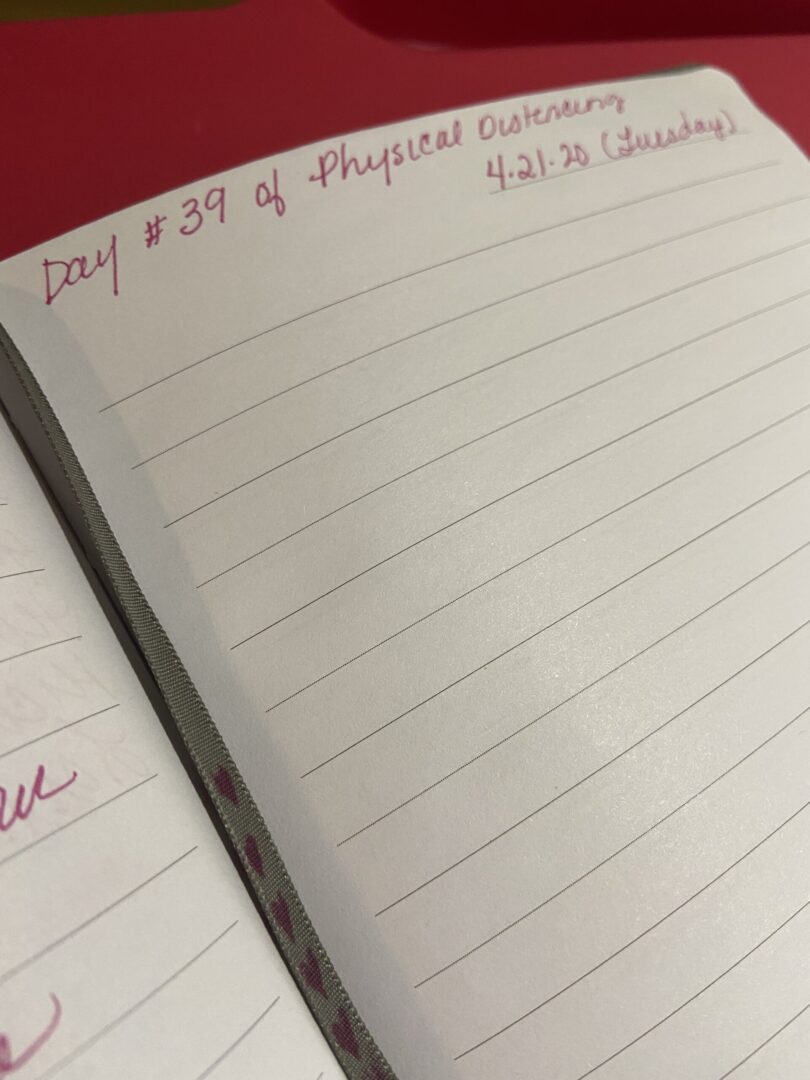 A notebook with lines written in red ink.
